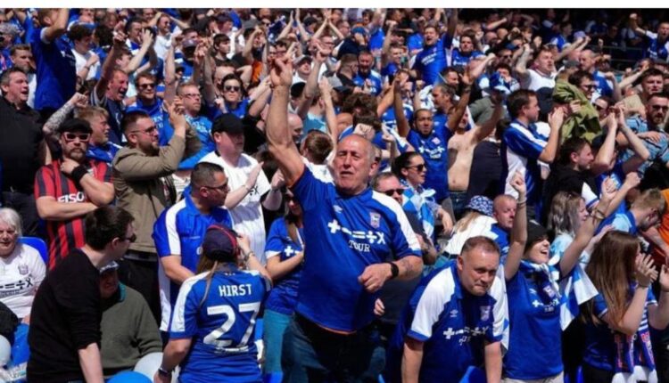 Ipswich Town supporters celebrate their promotion to the Premier League.